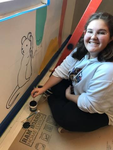 Washington High School faculty and students hand-paint their mural in Dax's Playroom at the Peoria Ronald McDonald House® in Peoria, Illinois.