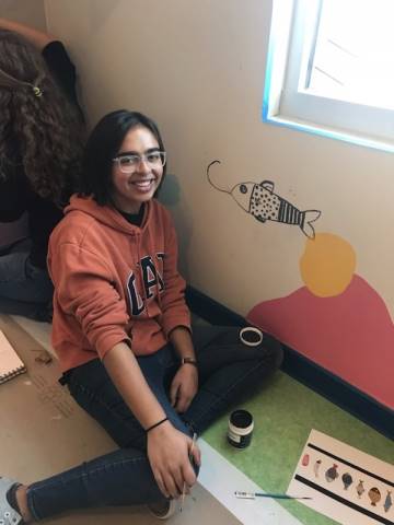 Washington High School faculty and students hand-paint their mural in Dax's Playroom at the Peoria Ronald McDonald House® in Peoria, Illinois.