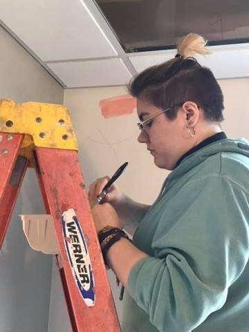 Washington High School faculty and students hand-paint their mural in Dax's Playroom at the Peoria Ronald McDonald House® in Peoria, Illinois.