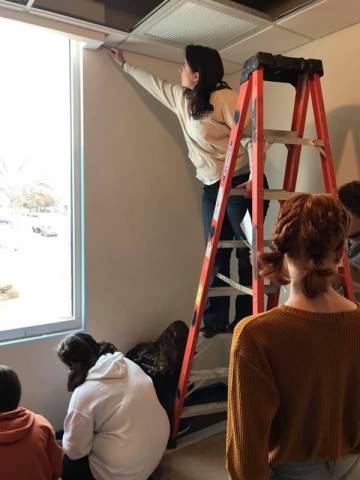 Washington High School faculty and students hand-paint their mural in Dax's Playroom at the Peoria Ronald McDonald House® in Peoria, Illinois.