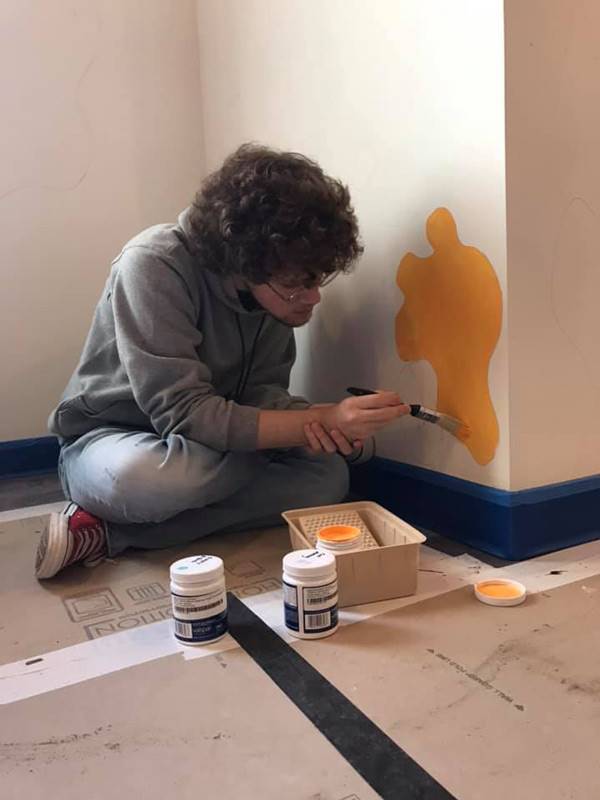 Washington High School faculty and students hand-paint their mural in Dax's Playroom at the Peoria Ronald McDonald House® in Peoria, Illinois.